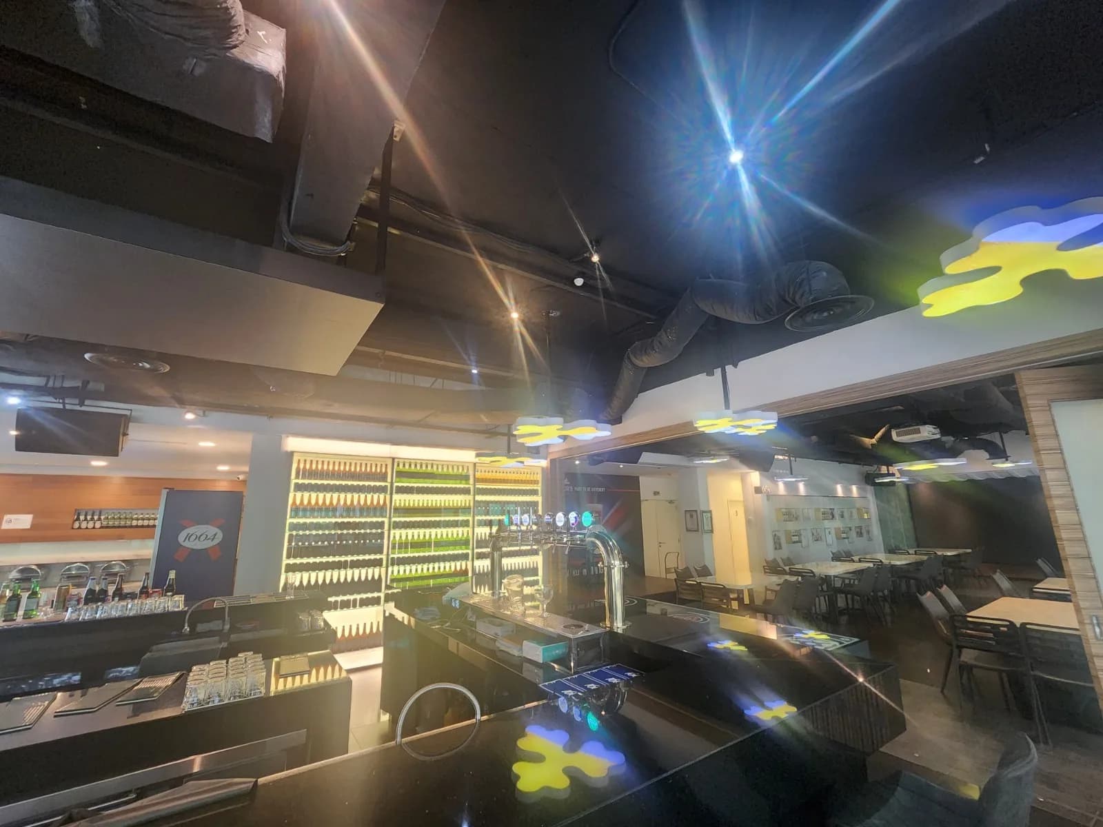 PTBL: Wide view of the bar and illuminated bottle display — actual site photograph
