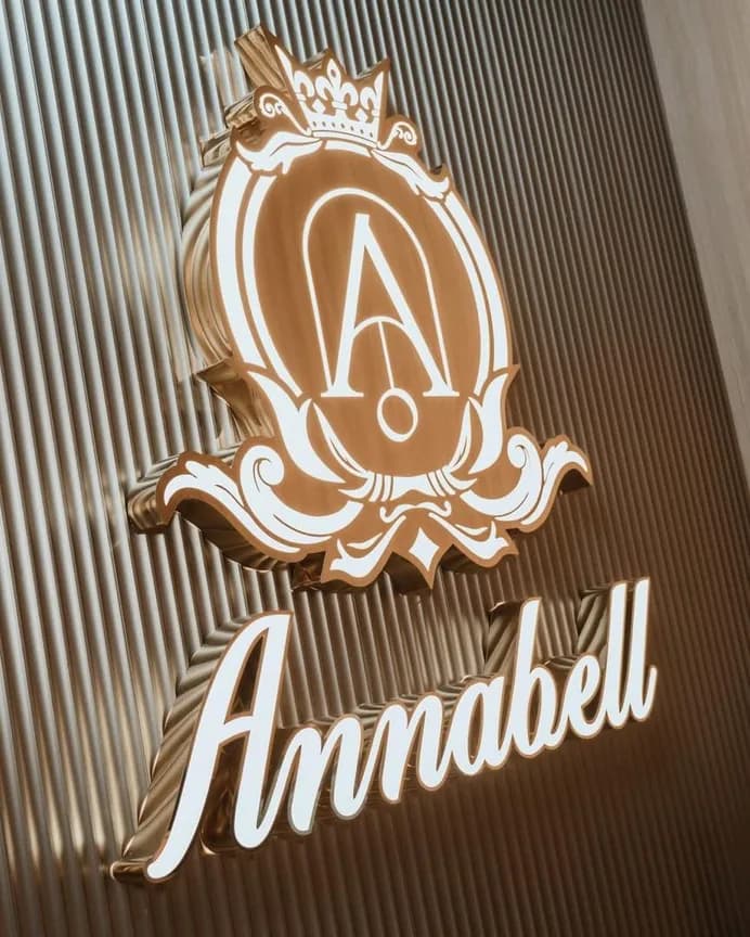 Illuminated gold Annabell lettering and crest on a fluted feature wall