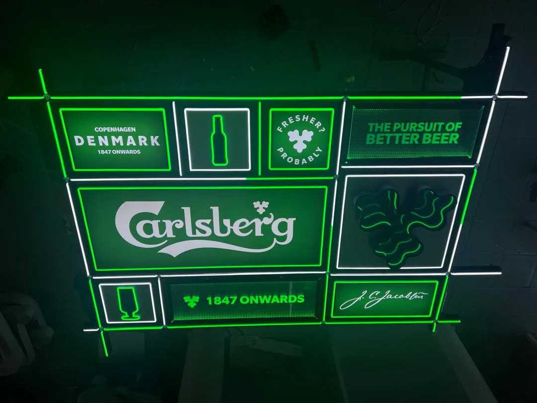Completed Carlsberg signage with green and white illuminated outlines