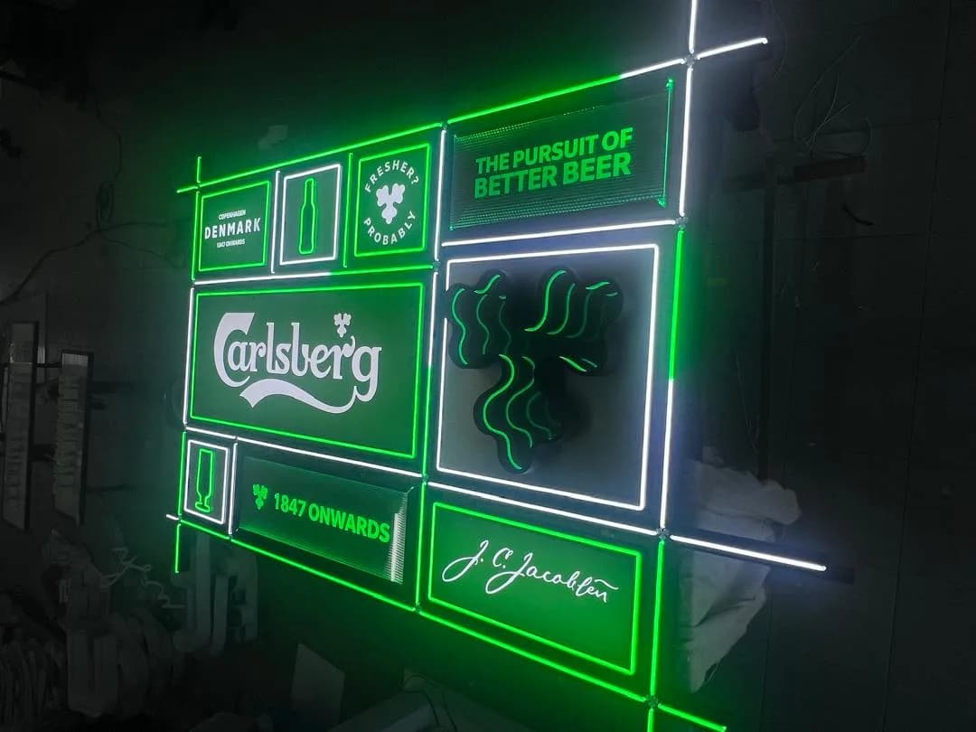 Carlsberg Signage: Carlsberg lettering and illuminated brand panels, angled view — actual site photograph