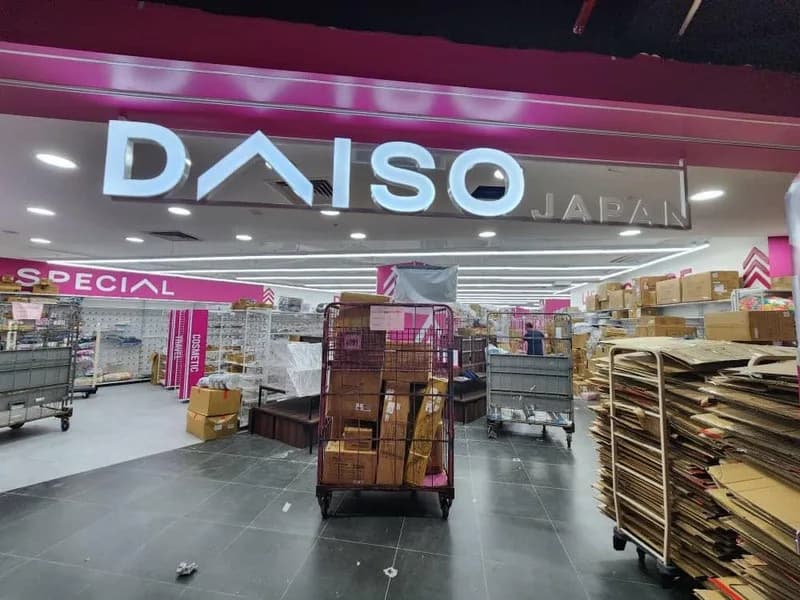 Daiso: Illuminated Daiso storefront fascia above the entrance — actual site photograph